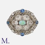 BUCCELLATI. An Opal, Sapphire and Diamond Brooch in yellow gold and silver, set to the centre with a