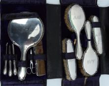 Antique silver hairdressing/toiletry set in a purple velvet leather case, consisting of two hairbrus