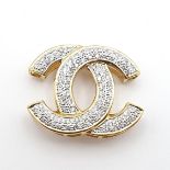 A Diamond Brooch formed as two Cs pavé-set numerous brilliant-cut stones, stamped 750, 35mm wide,