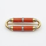 An Art Deco Coral and Diamond Brooch, two bars of coral inset with collars of white metal set