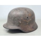 A German Luftwaffe WWII M40 type Helmet with Eagle emblem to one side, complete with leather liner