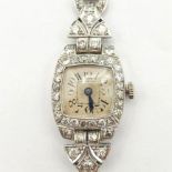 An Art Deco Diamond Cocktail Watch, the silvered enamel dial having Arabic numerals in a frame of