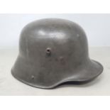 A German WWII M16/17 Shell Helmet complete with leather liner and chin strap, hand painted '