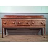 An oak Dresser Base with slightly raised back fitted with three drawers raised on tall square