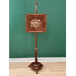 A Victorian rosewood Pole Screen with tapestry panel on circular base with three carved scroll