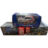 Three Boxed Die-cast Model Cars including Bburago Ford Focus WRC and 1:18 Scale Mini Cooper and