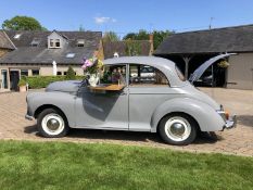 A stunning 1965 Bar-Converted Grey Morris Minor that transforms any event into a celebration of clas