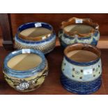 Collection of Doulton Stoneware jardinières of baluster and conical form, overall decorated with