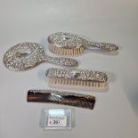 Art Nouveau silver repoussé four piece lady’s dressing table set to include hand mirror, brushes and
