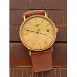 A Longines gold tone wristwatch with champagne dial and date aperture, fitted with a brown leather