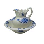Ironstone washstand jug and basin set decorated with blue floral sprays including tulips and roses