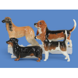Four dog breed figurines comprising Beswick Afghan Hound (14cm), Beswick Bloodhound (13cm), Beswick