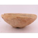 A Chinese terracotta oil lamp or shallow vessel, possibly Han Dynasty, of simple rounded form with