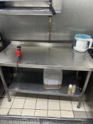 Stainless steel table with under shelf and back splash 130cm x 65cm x 82cm Note this lot has a