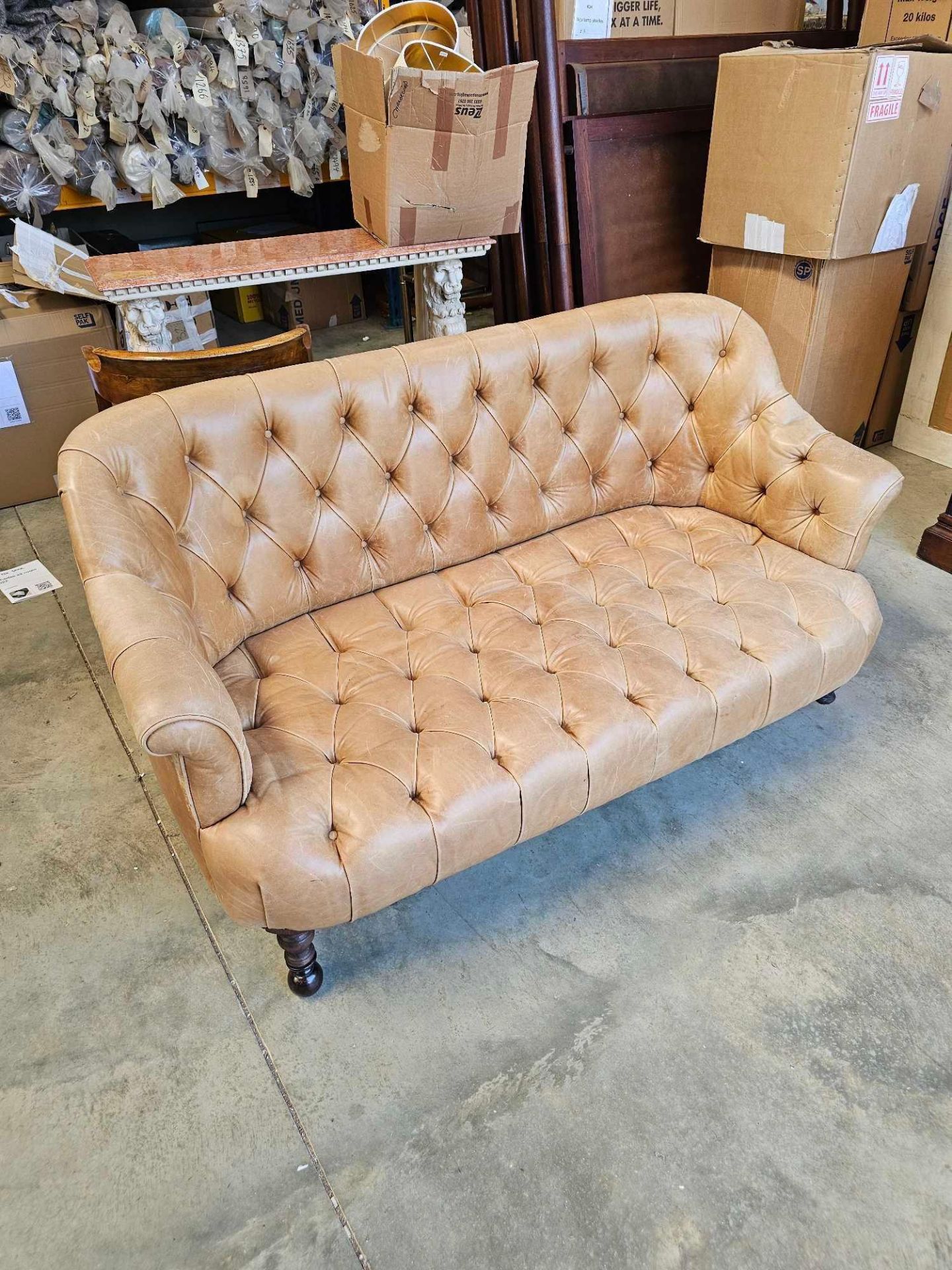A Chesterfield Style Two Seater Leather Sofa Tufted Back Seat Pad And Interior Of Arms In A Tan