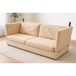 A two-seater Knole-style sofa upholstered in a gold velveteen fabric, featuring distinctive high,