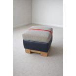 A contemporary square ottoman footstool or dressing seat from the bespoke British manufacturer