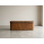 A grand contemporary woven rattan ottoman storage chest / blanket box of elongated rectangular form.