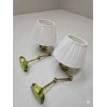 A pair of premium contemporary polished brass extending swing-arm wall sconces of classic