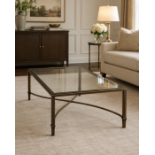 A Contemporary Bronzed Metal and Glass-Topped Coffee Table The table features a substantial