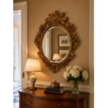 Chippendale Style Oval Gold-Gilt Wall Mirror A heavily carved openwork frame decorated in the Rococo