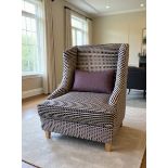 A Contemporary Art Deco Revival Wingback Accent Chair The accent chair features a high, straight