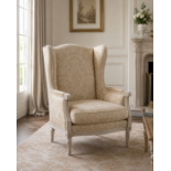A Louis XVI Style Carved Beechwood Wingback Armchair (Bergère à Oreilles) A high-back winged
