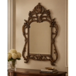 A Mid-20th Century Chippendale Style Carved Giltwood Wall Mirror The mirror features an arched