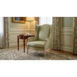 A Louis XVI Style Carved Beechwood Wingback Armchair (Bergère à Oreilles) A high-back winged