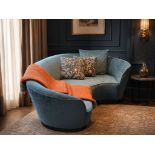 A contemporary teal blue crescent-shaped curved sofa, expertly upholstered in premium velvet from