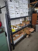 TEAR DROP SHOP RACK FULL OF SECURITY CAMERA SYSTEM HARDWARE, ACCESSORIES AND SUPPLIES