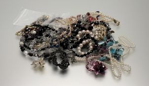 A collection of costume jewellery to include a garnet bead necklace with white metal leaf and flower