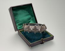 A late 19thc Eastern white metal stiff-hinged bangle with five panel studed deisgn to front: d. x