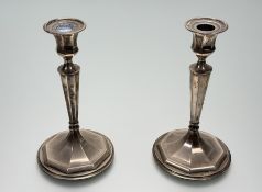 A pair of Danish Sterling silver weighted baluster octagonal table candlesticks on circular