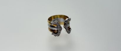 A modern 18ct two coloured gold French-style buckle ring with each terminal set with eleven
