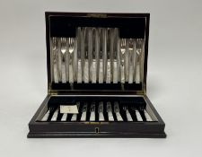 An Edwardian mahogany canteen containing a set of twelve pairs of epns mother of pearl fruit