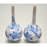 A pair of 20thc Japanese blue and white water dropper vases, with hand-painted bird and