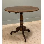 An early 20th-century mahogany tripod table, snap-top raised on baluster support and splayed