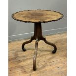 A George III tilt-top tripod table, the circular piecrust top over an incurved standard on scroll