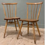 A pair of Ercol Model 391 elm and beech chairs, spindle backs and saddle seats, raised on turned
