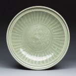 A Chinese Longquan celadon dish with incised floral design, Ming