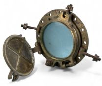 BRONZE SHIP'S PORTHOLE with glass window and cover, with retaining clasps, 40cms (diam.) Provenance: