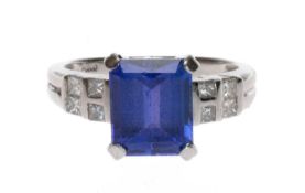PLATINUM TANZANITE & DIAMOND RING, the emerald cut tanzanite approx. 3.4ct, with eight princess-