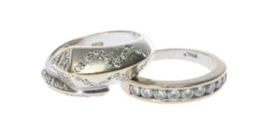 TWO WHITE METAL DIAMOND RINGS, comprising nine-stone round-cut diamond ring and diamond chip twist