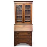OAK BUREAU BOOKCASE of narrow form, circa 1900, with leaded glazed upper doors, drop-down middle,