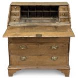 VICTORIAN OAK BUREAU, having drop-down surface over three drawers with brass drop handles and