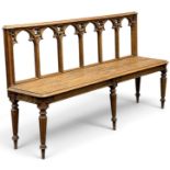 VICTORIAN GOTHIC REVIVAL OAK HALL BENCH, circa 1860-1880, the back with Gothic arches over a solid