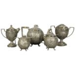 ANGLO-INDIAN WHITE METAL THREE-PIECE TEA SERVICE, late 19th century, decorated with intricate chased