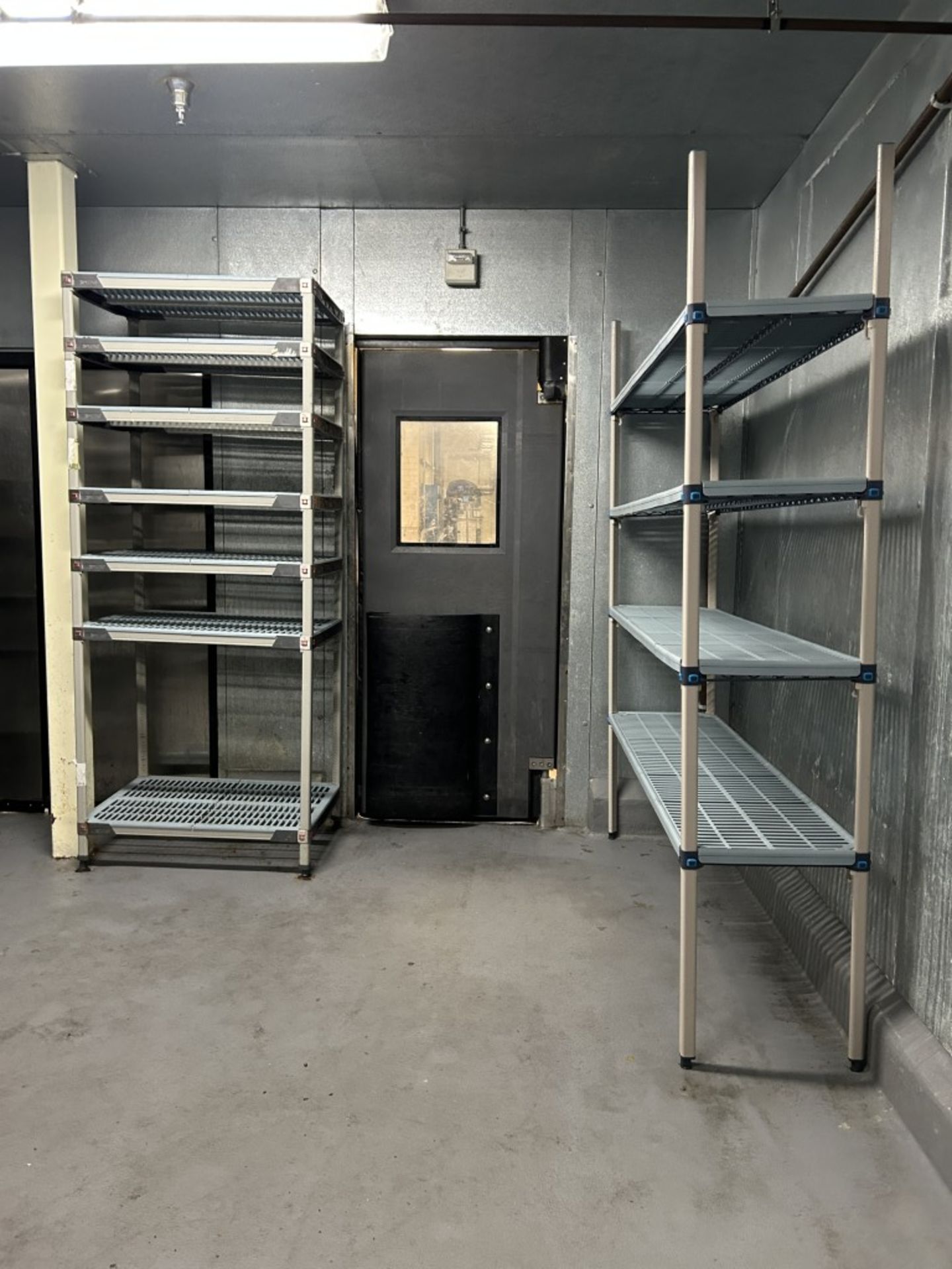 Wall Metro Racking ASSORTED PLASTIC METRO RACKS IN WALK-IN COOLER