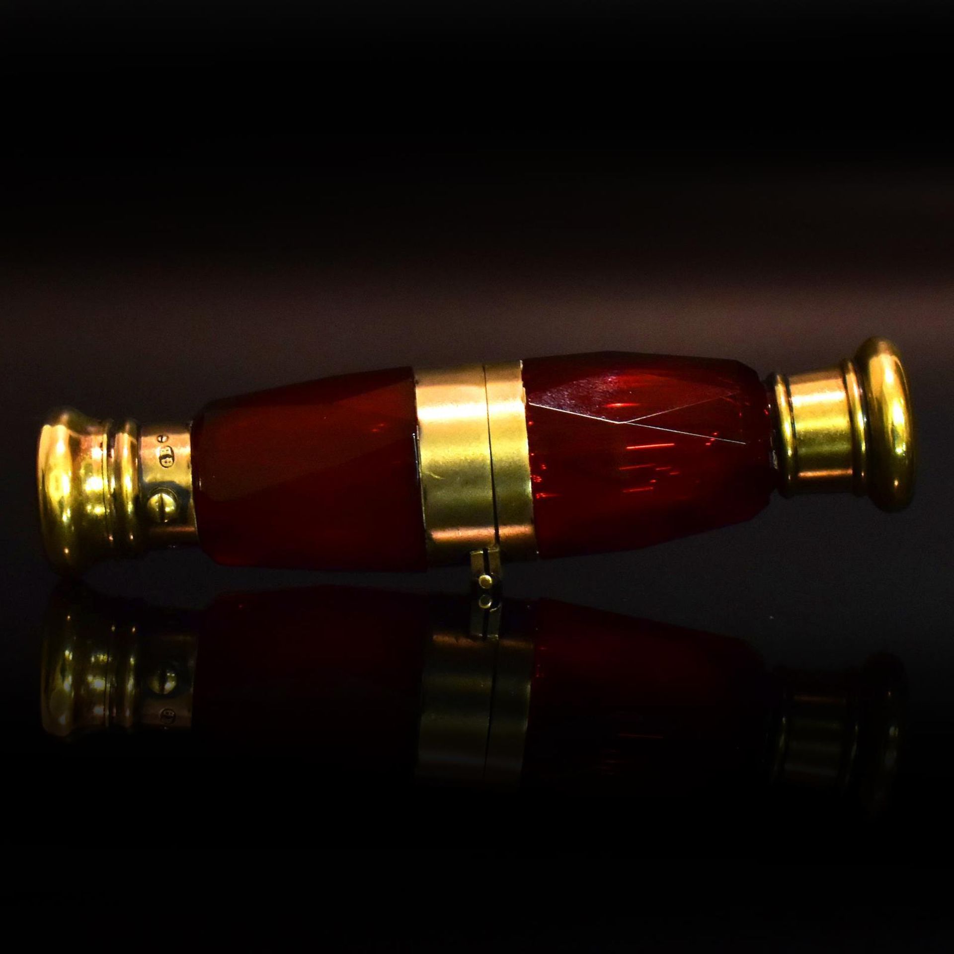 Doppelflakon. Wohl England, Ende 19. Jh. | Farbloses Glas mit Goldrubinunterfang. Vermeilmontierung.